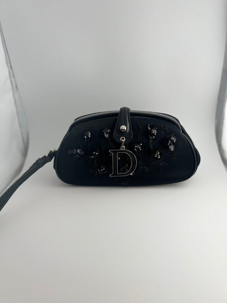 black Dior wristlet with embroidered flowers